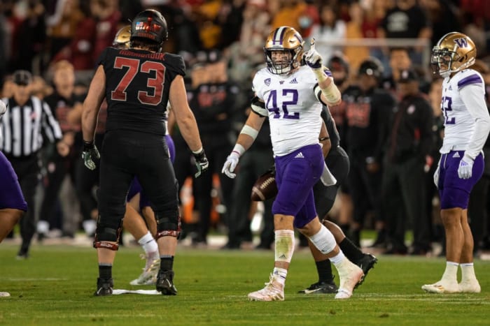 Washington linebacker Carson Bruener (42) celebrates a tackle against Stanford.